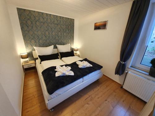 Postel nebo postele na pokoji v ubytování FeWo-Butze 2 mit Terrasse
