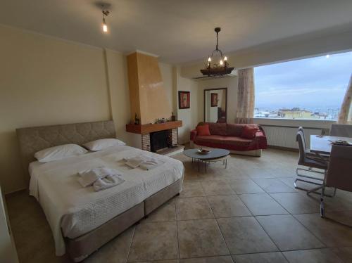 a bedroom with a bed and a living room at Private pool & Panorama View on Athens center Hill in Athens