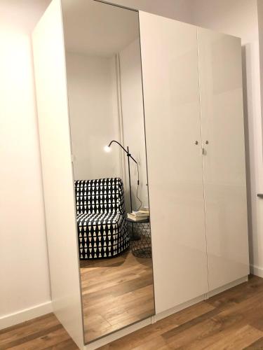 a large mirror in a room with a chair at Apartament RadMila2 in Radom