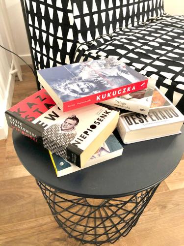 a pile of books sitting on top of a table at Apartament RadMila2 in Radom