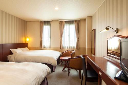 Postel nebo postele na pokoji v ubytování TsukubaNoYu Urban Hotel
