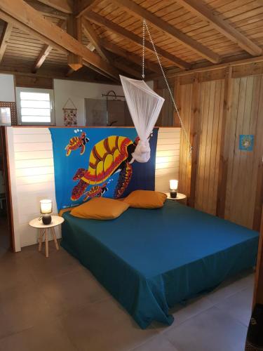 sypialnia z łóżkiem ze smokiem w obiekcie Cocktail Caraïbes, Résidence de Tourisme Meublée w mieście Saint-Louis