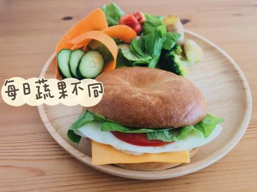 a plate of food with a sandwich and a salad at HELLO Make Yourself at Home in Kenting