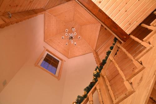 a ceiling with a chandelier in a room at Котедж Соняшник in Verkhovyna