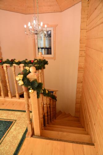 a staircase in a house with christmas decorations at Котедж Соняшник in Verkhovyna