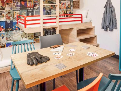 a table with gloves on it in a room at hotelF1 Roissy CDG Pn2 in Roissy-en-France
