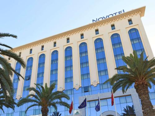 a building with a sign on top of it at Novotel Tunis in Tunis