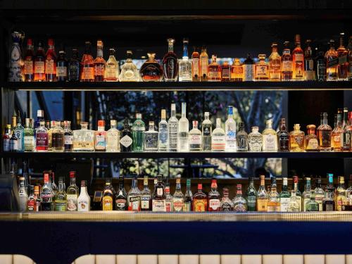 a bar filled with lots of bottles of alcohol at Pullman Melbourne On the Park in Melbourne