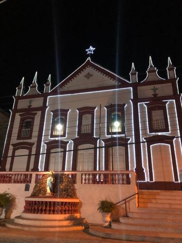 a large white building with a star on the front at Chalé Suíço - Chalés Belo Monte - Sítio Belo Monte in Pacoti