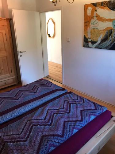 a bedroom with a bed and a painting on the wall at Villa Nussbaum in Golling an der Salzach