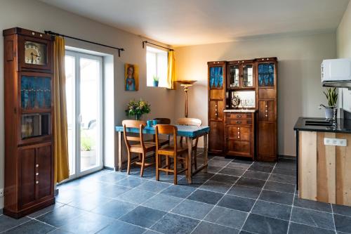 a kitchen with a table and chairs in a room at B&B Art.14 in Morkhoven