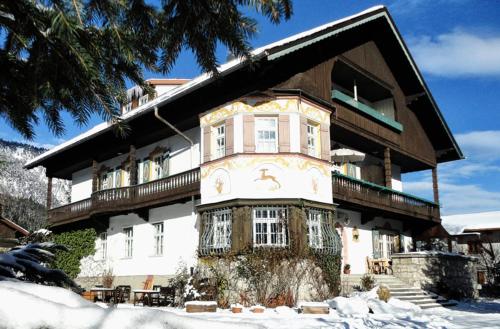 a large house in the snow in front at Gästehaus Hohe Tannen in Garmisch-Partenkirchen