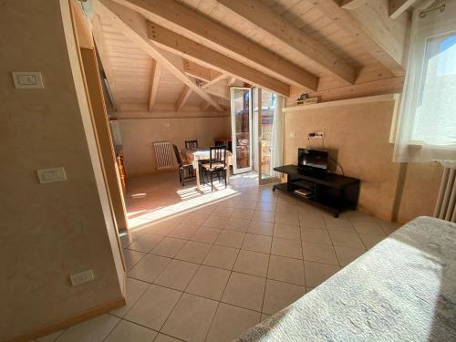 a bedroom with a bed and a dining room with a table at Appartamenti Jamaica in Sirmione