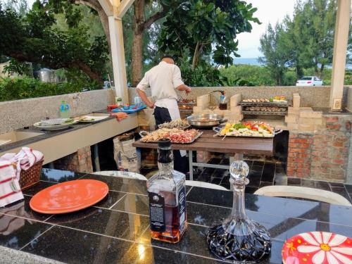 a man preparing food on a table on a patio at Kenting COMIC B&B&SPRING in Hengchun