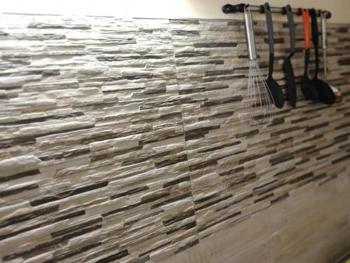 a faux stone wall in a room with a stone wall at F2 familial - Vue imprenable sur la baie du Marin in Le Marin