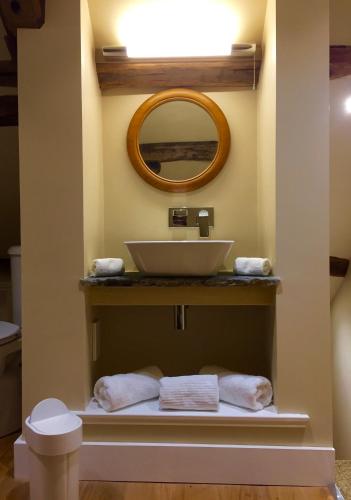 a bathroom with a sink and a mirror at The Coach House in Austwick