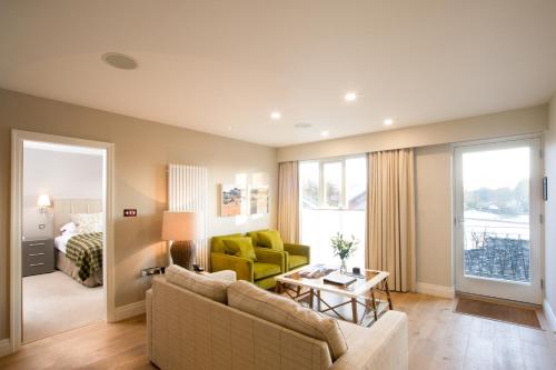 a living room with a couch and a table at Holbeck Ghyll Country House Hotel with Stunning Lake Views in Windermere