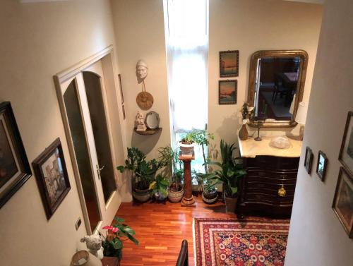 a hallway with a sink and a mirror and plants at Casa di Anna in Ravenna