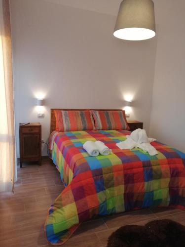 a bedroom with a colorful bed with towels on it at B&B Belli Dentro in Verona