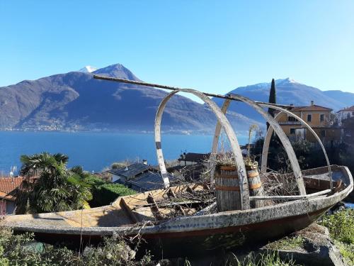 an old boat sitting on the side of a mountain at AnMa Cottages The Secret Garden in Pianello Del Lario