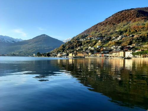 a view of a lake with houses on a hill at AnMa Cottages The Secret Garden in Pianello Del Lario