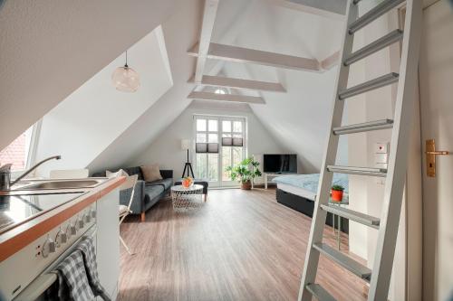 a kitchen and living room with a ladder in a room at Altstadt Apartments Verden in Verden