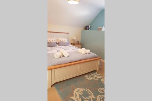 a bedroom with a bed with white towels on it at Nolton Haven Farmhouse Apartment, Sea Views in Haverfordwest