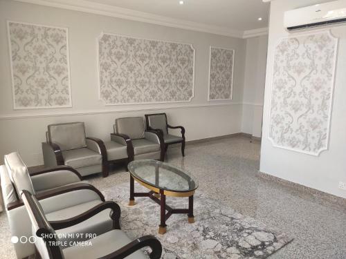 a waiting room with chairs and a glass table at Conference Hotel , Abeokuta in Abeokuta