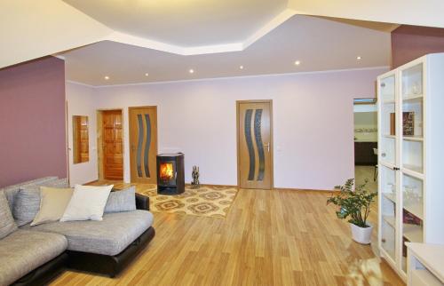 a living room with a couch and a fireplace at Apartments by the lake with fireplace in Trakai