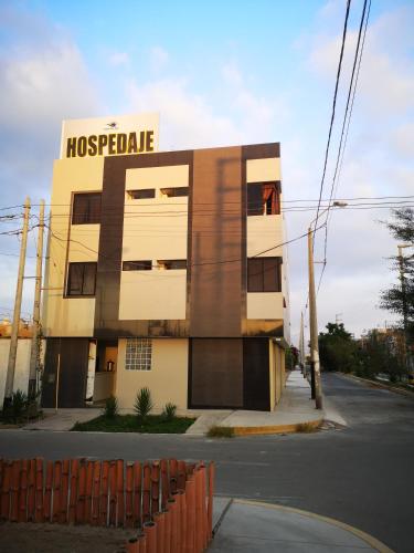 a building with a sign on the side of it at Hospedaje Villa Del Sol in Ica