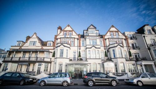 a large building with cars parked in front of it at The Kingswood Hotel in Sidmouth