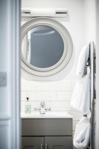a bathroom with a sink and a mirror at The Kingswood Hotel in Sidmouth