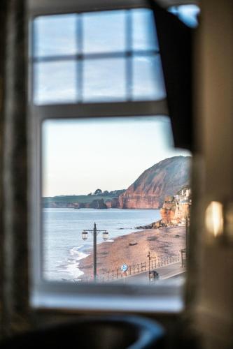 a view of a beach from a window at The Kingswood Hotel in Sidmouth