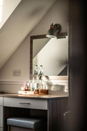 a bathroom with a sink and a mirror at The Kingswood Hotel in Sidmouth