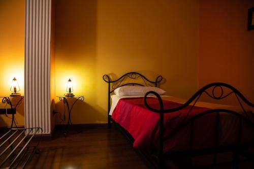 a bedroom with a bed with a red blanket at Arcobaleno Guest House Pellaro in Pellaro