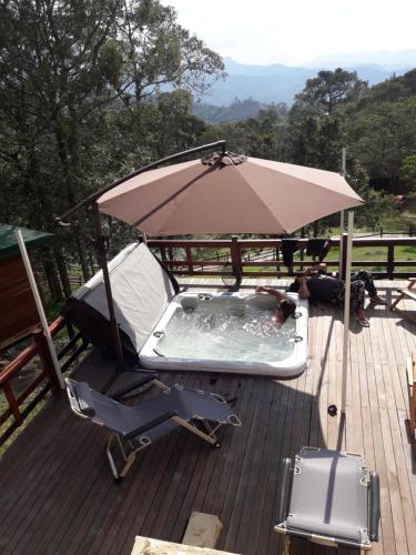 a patio with an umbrella and a chair and a pool at Condominio Hacienda Shangrila in San Francisco