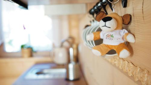 a stuffed teddy bear hanging on a wall at Wioska Jasia i Małgosi in Izdebnik