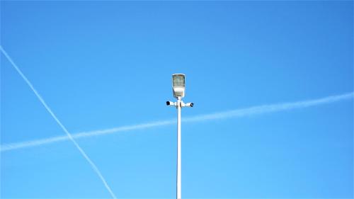 a street light in a blue sky with at Wioska Jasia i Małgosi in Izdebnik