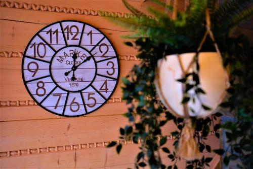 a clock is hanging on a wall at Wioska Jasia i Małgosi in Izdebnik