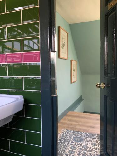 a bathroom with a sink and a door at Mulberry Cottage, Bowden in Melrose