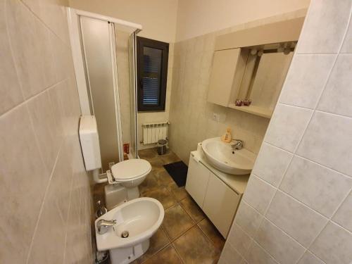 a bathroom with two toilets and a sink at Casa Bach in Piacenza