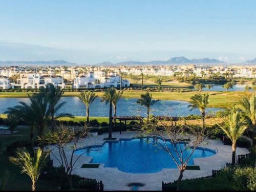 un complejo con una gran piscina y palmeras en Casa Emperador Penthouse, en Roldán