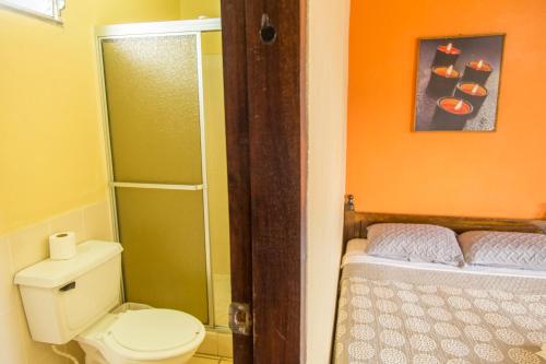 a small bathroom with a toilet and a shower at Berakah B&B- Central Park in Copán Ruinas