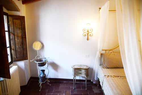 a bedroom with a bed and a chair in a room at La Terrazza sul Borgo - Montefioralle Apartment in Greve in Chianti