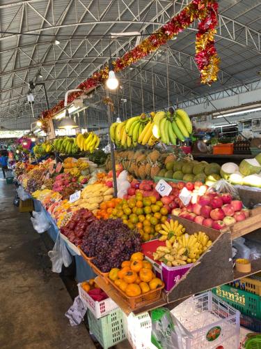 a market with a display of fruits and vegetables at Jomtien Beach Hostel & Guesthouse in Jomtien Beach