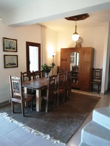 a dining room with a wooden table and chairs at Deluxe house in Tsangarada in Tsagarada