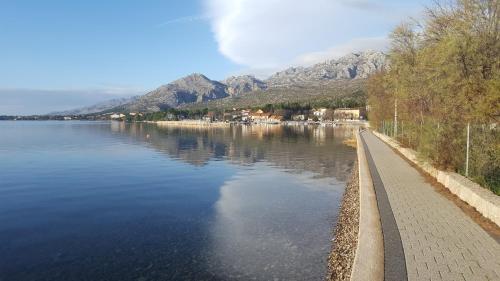 a view of a lake with mountains in the background at Stone house Goranova kuća in Seline