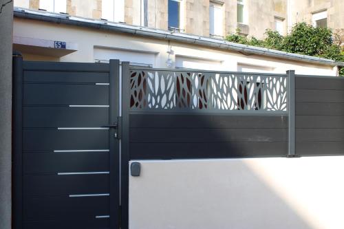 a black gate in front of a building at La Petite Maison in Brest