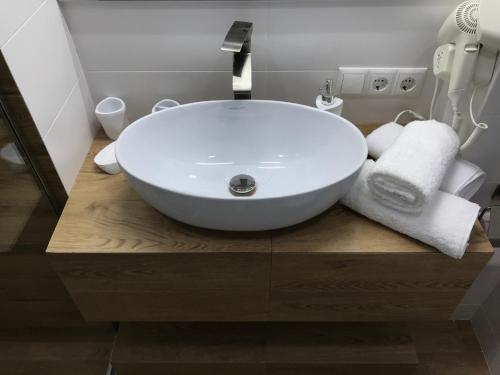 a bathroom with a white bowl sink on a wooden counter at New Gudauri, Red Co, Loft 1 in Gudauri