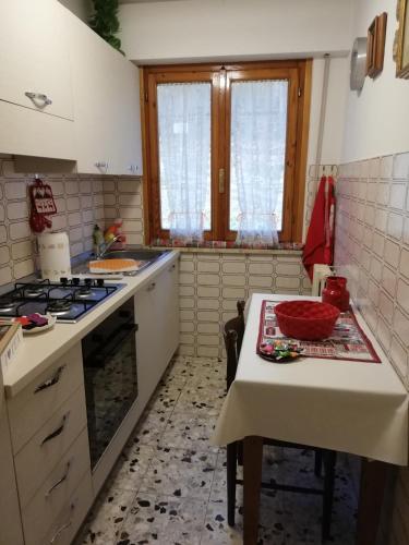 una cocina con una mesa y una estufa horno superior en Pratomagno Apartment, en Cetica